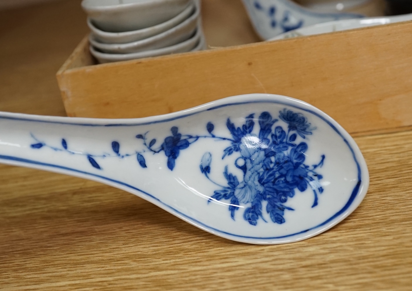 A small Chinese porcelain blue and white vase, Republic period, on a hardwood stand and various soup spoons, Guangxu/Republic period, vase 14cm high. Condition - good